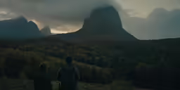 the couple is walking towards the beautiful scenery