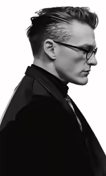 a person in glasses and a jacket with a neck tie