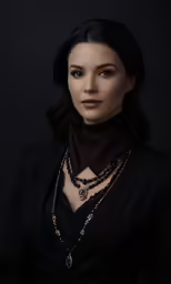 a woman in a black suit is wearing a gold and silver necklace