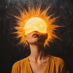 a woman looking up into the sky with orange hair on her head