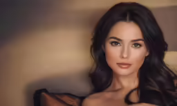 a model with long dark hair and no bra