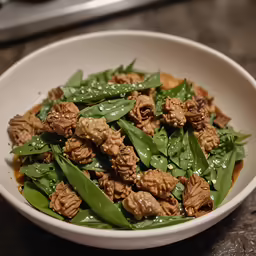 a white bowl filled with green vegetables and nuts