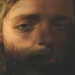 a very close up shot of a man with wet hair