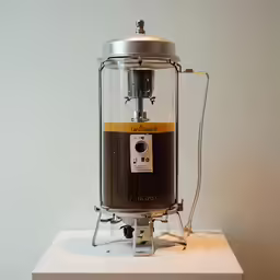 a machine for filling drinks onto a white table