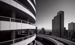 the balcony of a tall building near a street and a highway