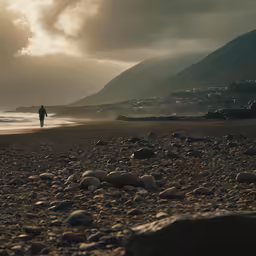 a person on the beach with rocky ground
