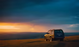 a truck parked on the side of a road at sunset