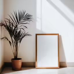 a wooden frame on a wall next to a plant