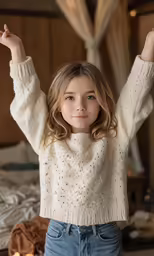 a beautiful young lady wearing jeans and a sweater