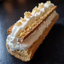 a cake with white frosting is sitting on a table