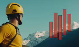 a man standing next to the mountains with a helmet