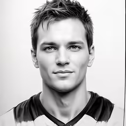 a soccer player wearing a jersey poses for a photo