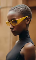 a model with sunglasses looking back at the camera