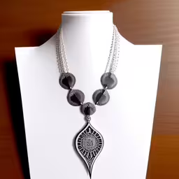 necklace with black and white beads on white mannequin,a necklace has been made out of wire