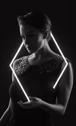 a woman with her hands folded up in front of a bright square frame