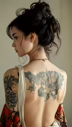 back view of a woman with tattoos and a floral dress