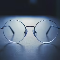 glasses with a metal frame sitting on a table