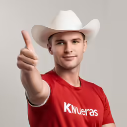 the man wearing a red shirt is pointing at something
