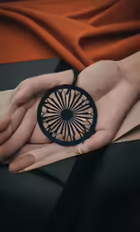 a woman holding her hand around the camera on a cushion