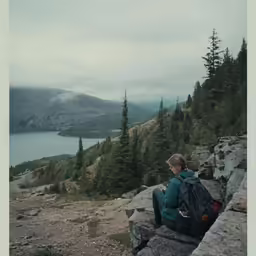 a man sits on top of a cliff