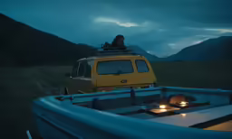 a car driving down a hill near a lake