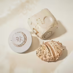 the white container is next to the white vase