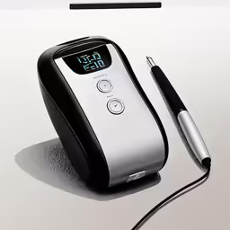 an electronic device sits next to a pen