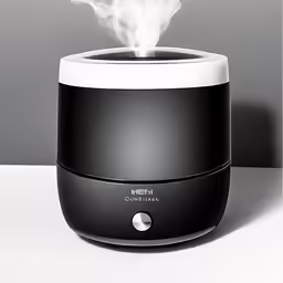 a black aroma diffuser is on display with smoke coming out