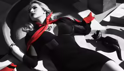 a woman in black and red laying on cement