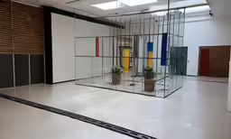 a room with a big window, door and several colors