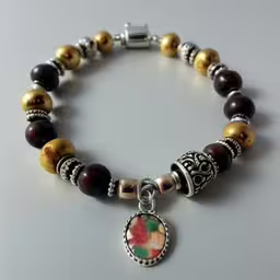 a bead bracelet has a floral heart and colorful flowers,a beaded bracelet with an evil skull charm