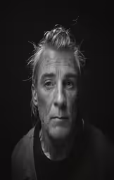 a black and white image of a man with frizz on his face
