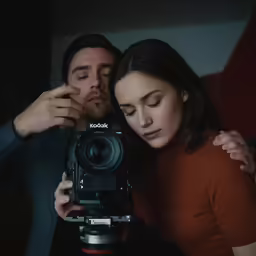 a man and woman with a video camera