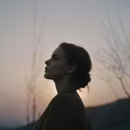 woman in profile while looking off into the distance