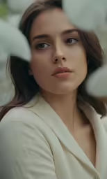 a young woman wearing a white shirt and posing