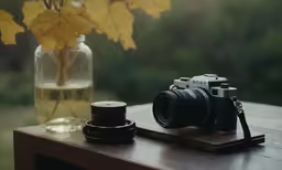 a camera and some flowers on a table