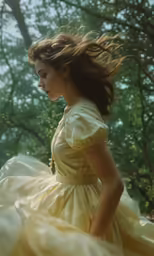 a young girl in a yellow dress in the woods