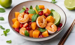 a bowl of fruit salad with shrimp and veggies