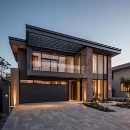 a modern house that has windows and lights on