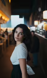 the woman in a white shirt is standing alone