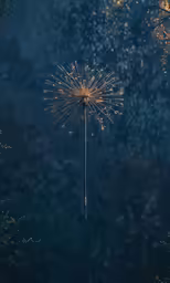a small gold and silver sparkler that is on the ground