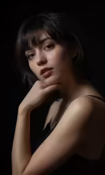 the image of a girl with a serious look, in the dark