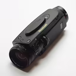 an open compact camera sitting on a white table