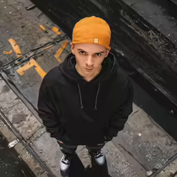 an aerial photo of a man looking down at the camera