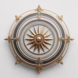 a very ornate gold and white compass clock