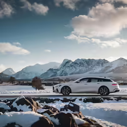 a white porsche cayen driving on a snowy road