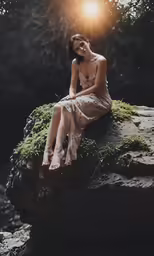 woman sitting on a rock near a stream