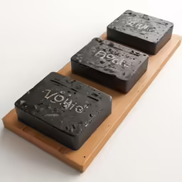 there are two square shaped objects on a wood block