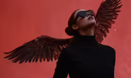 a woman with large, black wings on her head