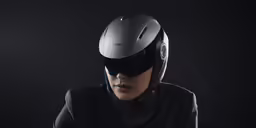 woman in a helmet with visor looking off to the side